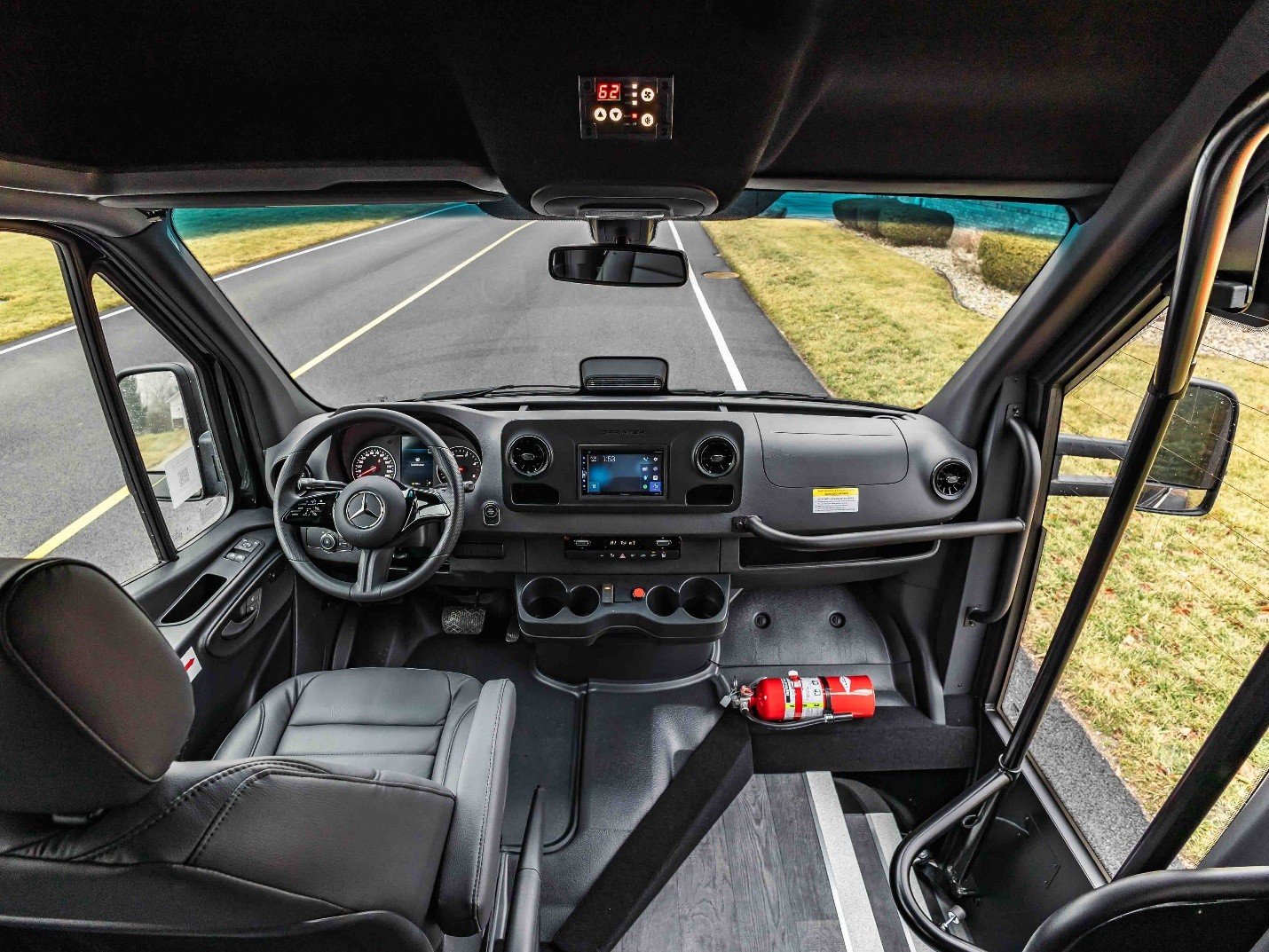 Plush black leather seating with ambient lighting inside a TESCO luxury shuttle